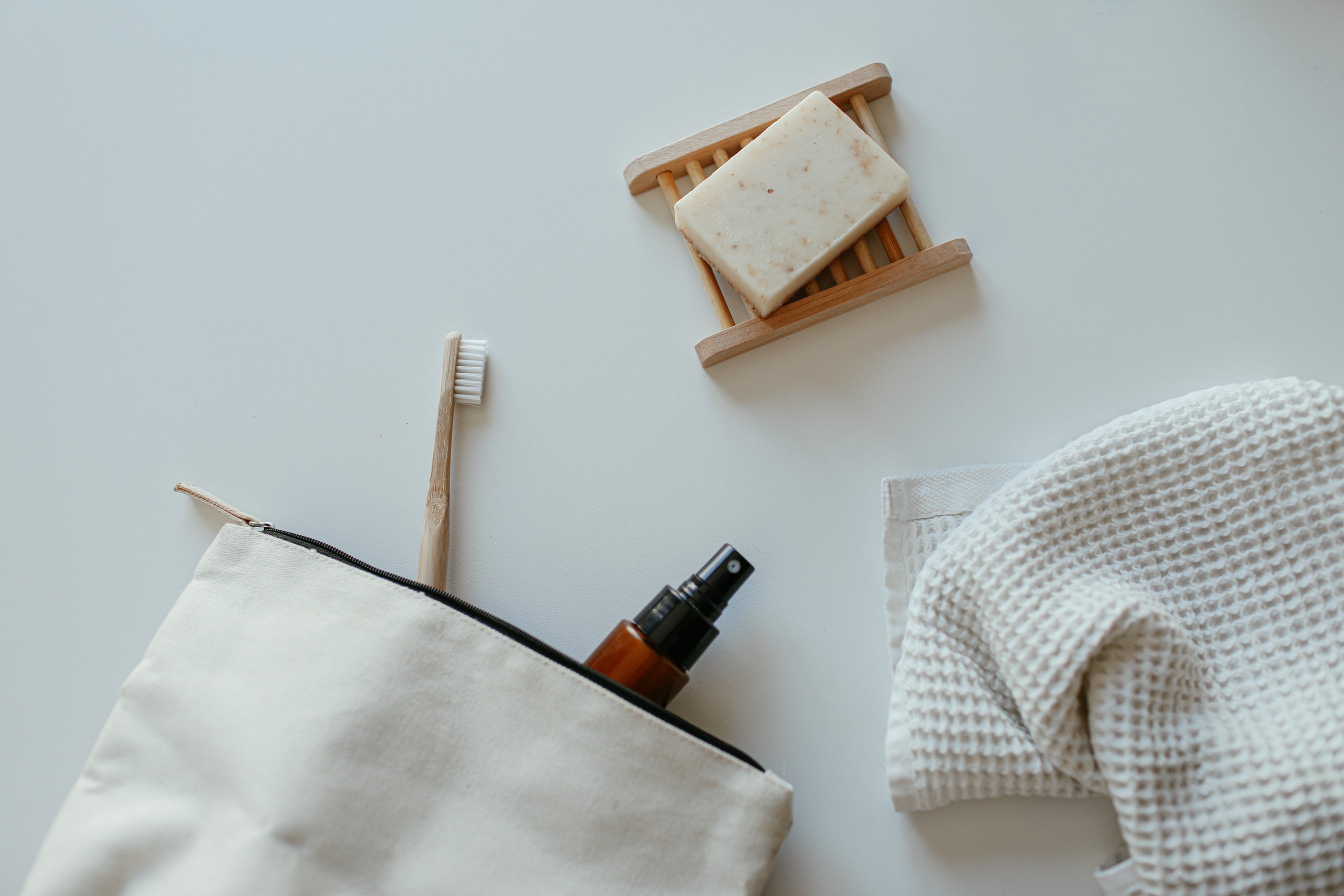 Soap, a Towel, a Toothbrush and a Spray Bottle in a Bag